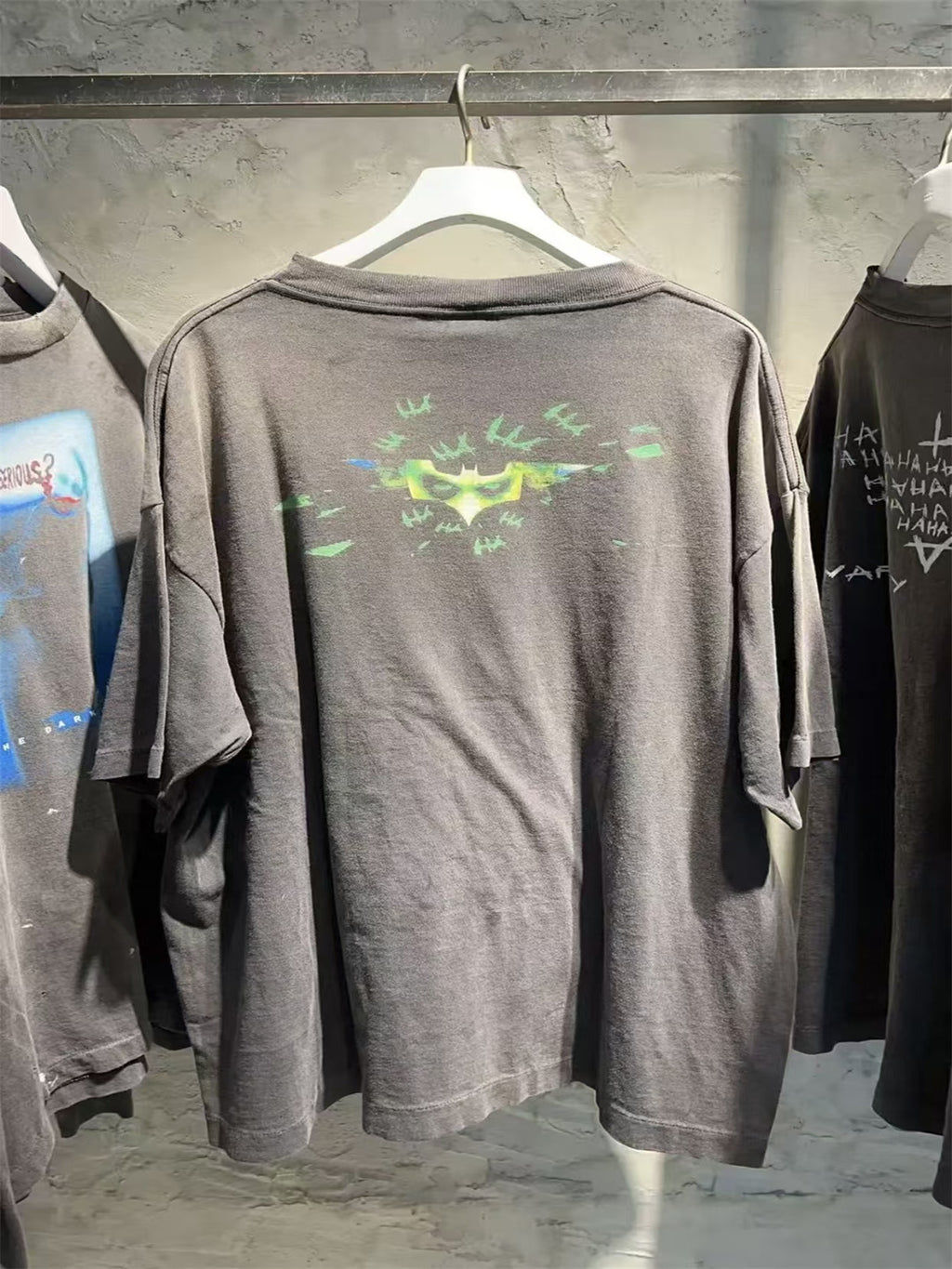 SAINT Mxxxxxx piece: Batman collaboration distressed T-shirt featuring a sun-faded gradient wash.