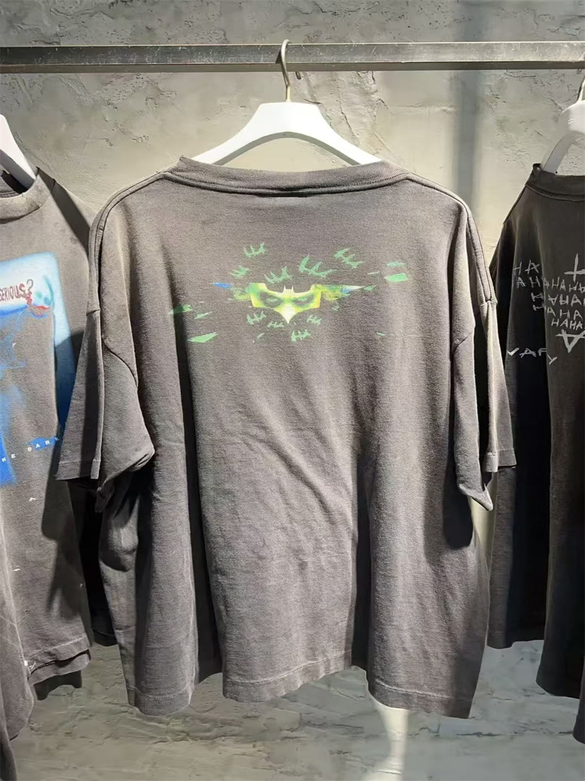 SAINT Mxxxxxx piece: Batman collaboration distressed T-shirt featuring a sun-faded gradient wash.
