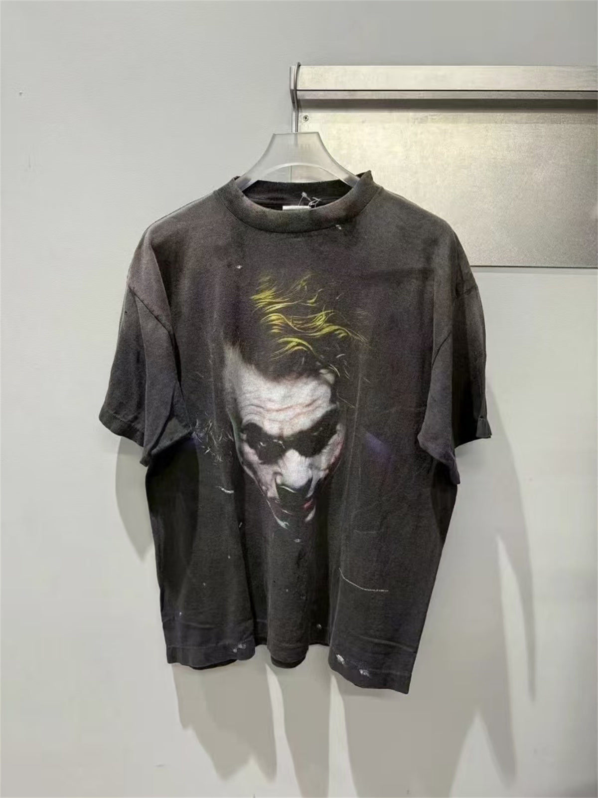SAINT Mxxxxxx piece: Batman collaboration distressed T-shirt featuring a sun-faded gradient wash.