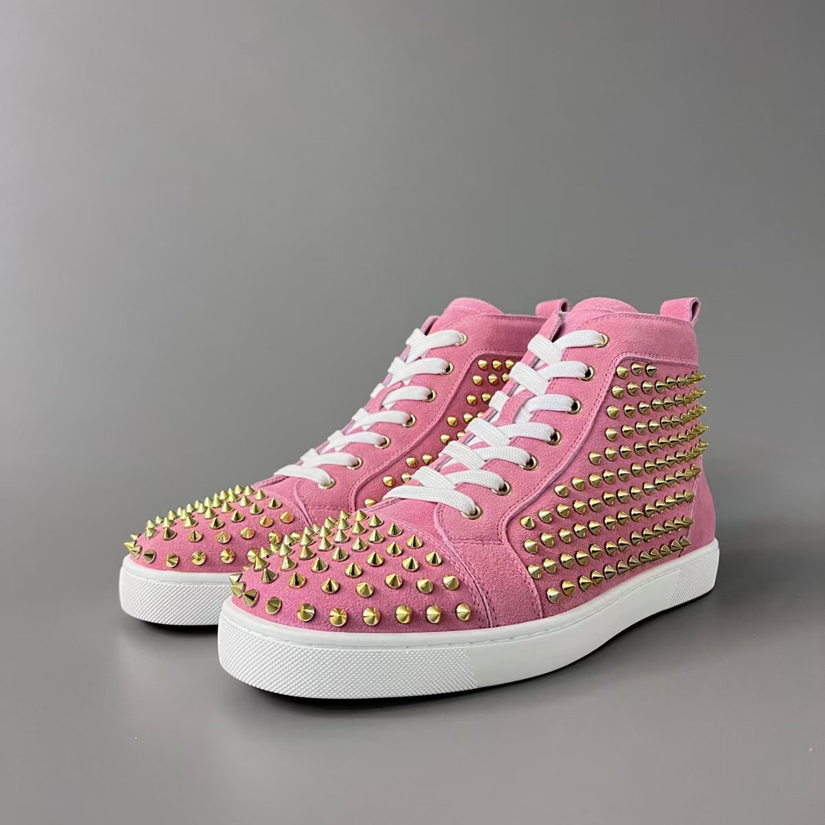 CL 【Red Sole】Lou Spikes high-top sneakers with pink-gold studs.