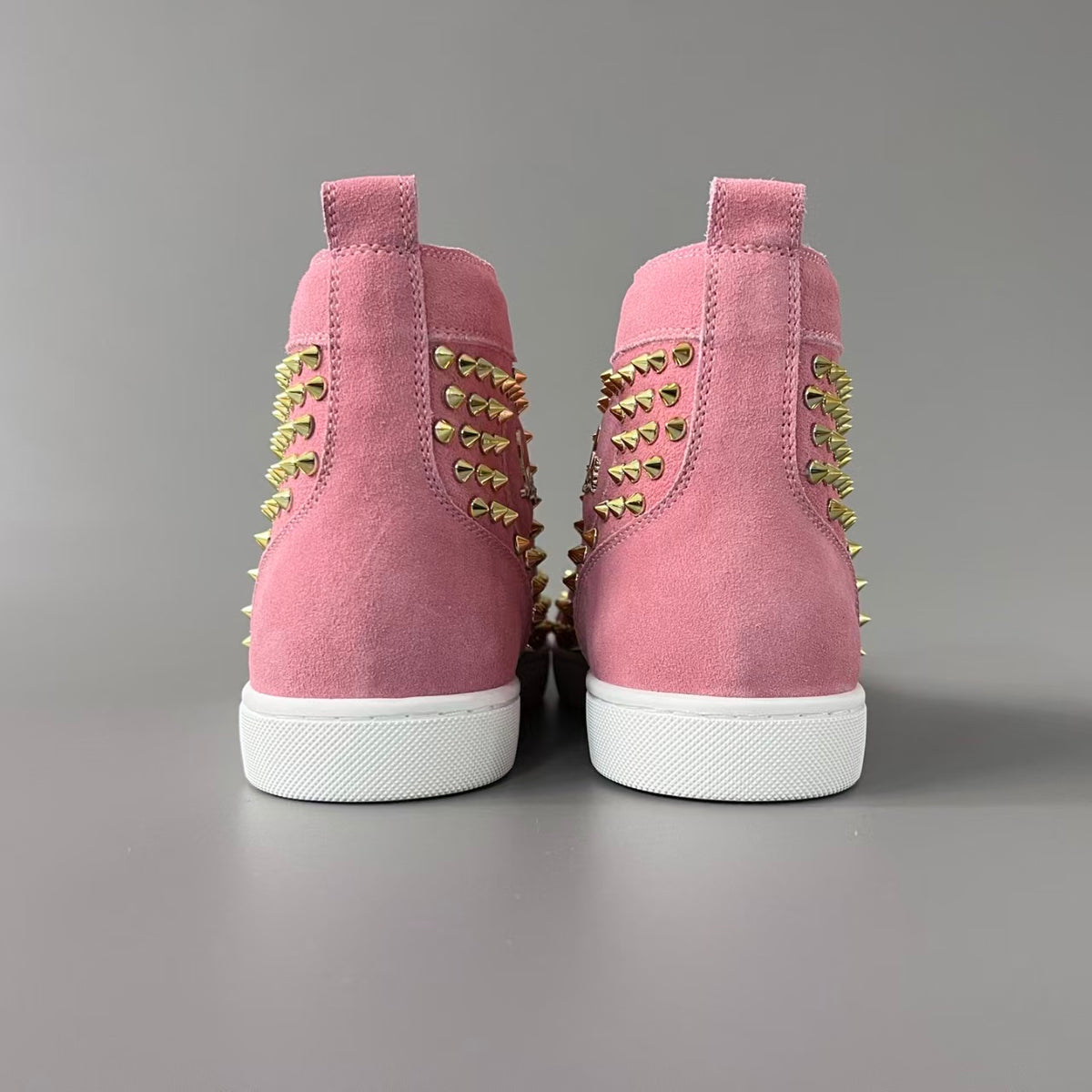 CL 【Red Sole】Lou Spikes high-top sneakers with pink-gold studs.