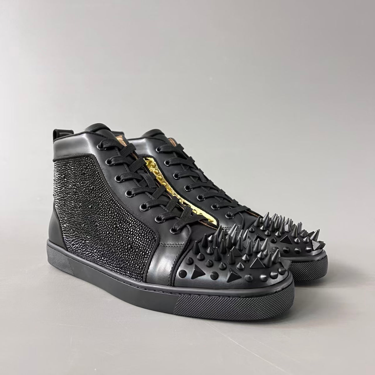 CL 【Red Sole】Lou Spikes high-top sneakers with black and gold studs.