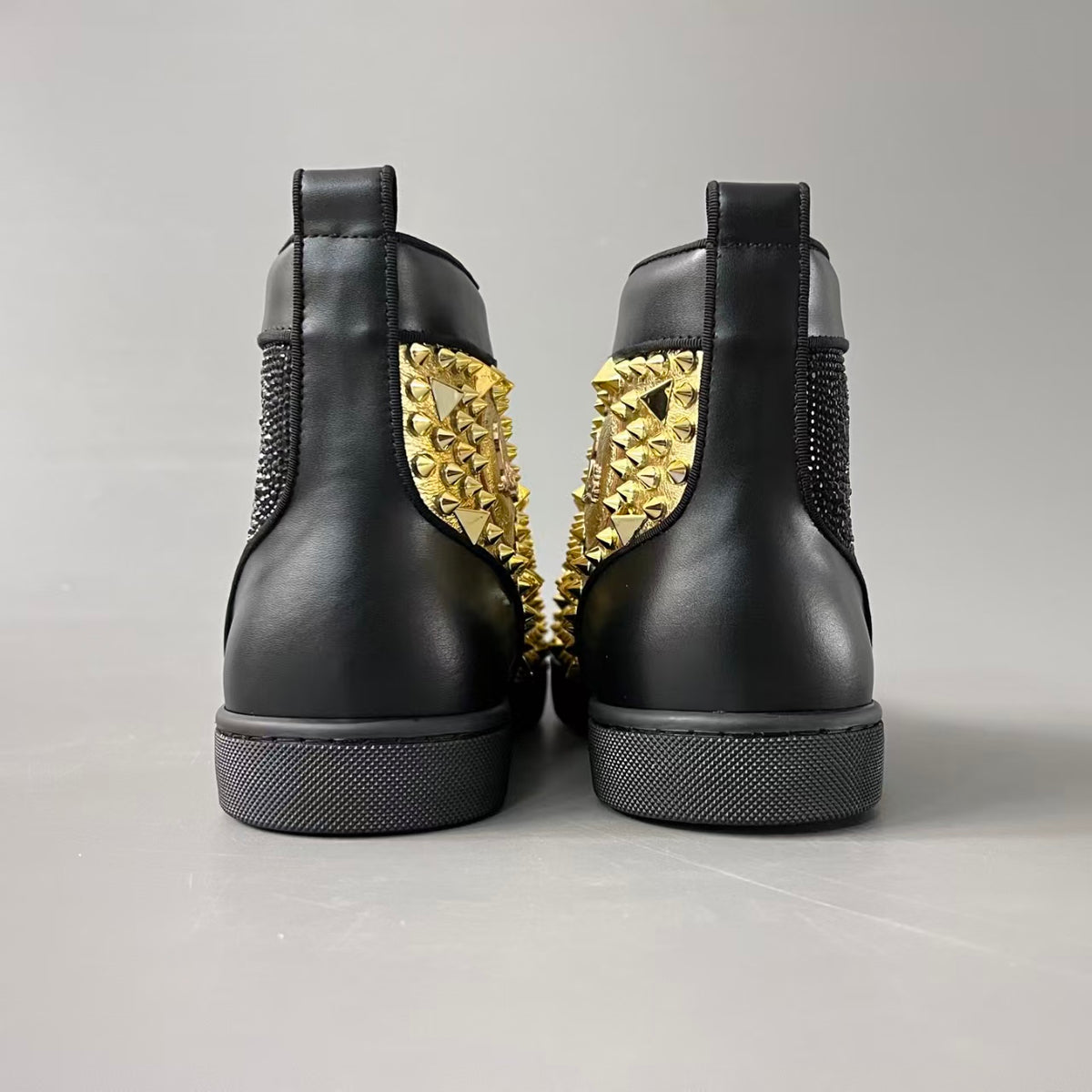 CL 【Red Sole】Lou Spikes high-top sneakers with black and gold studs.